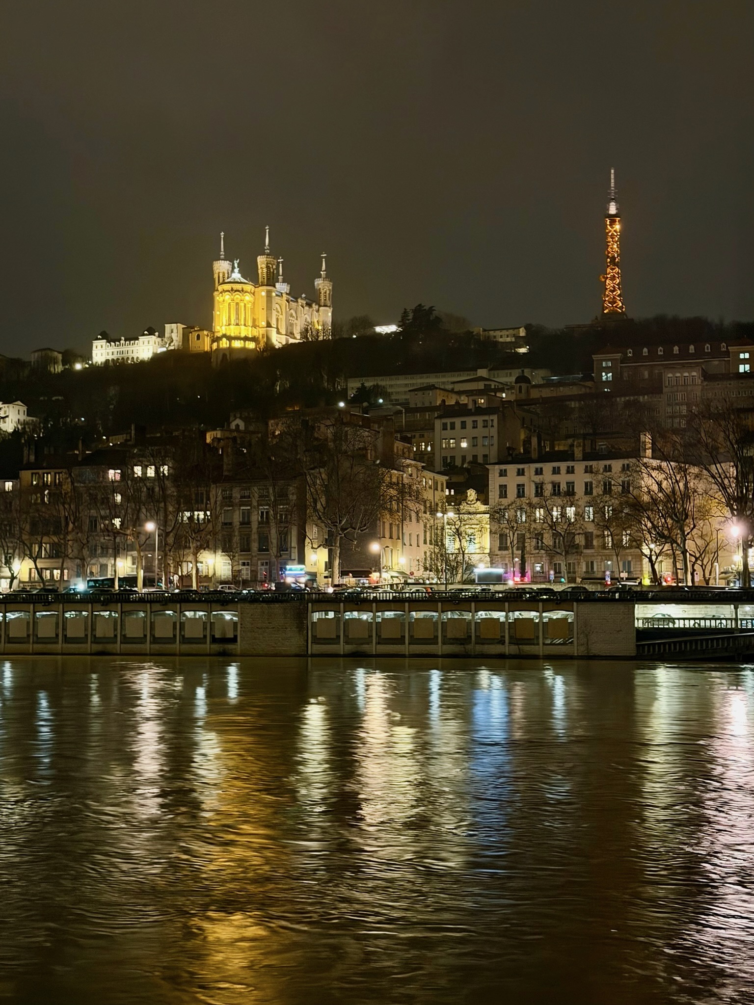 Lyon glowing along the river at night